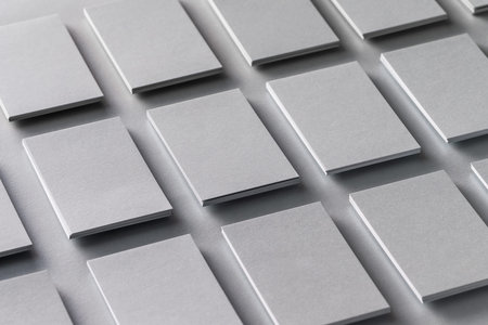 Mockup of vertical business cards stacks arranged in rows at grey textured paper background.の写真素材