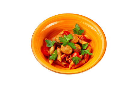 Closeup plate of pasta with tomato ketchup and chicken chop meat isolated at white background.の写真素材