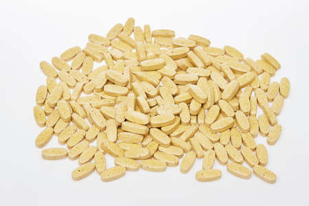 Scattered medicine isolated at white background. Pills as decease preventions. Vitamins and healthy lifestyle.の写真素材