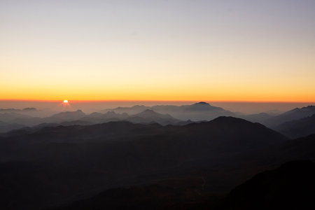 Beautiful sunrise view of Sinai mountains with the peaks in fog clouds.の写真素材
