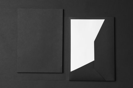 Corporate stationery set mockup. Closed and opened presentation folders with letterhead at black textured paper background.の素材 [FY310210507898]