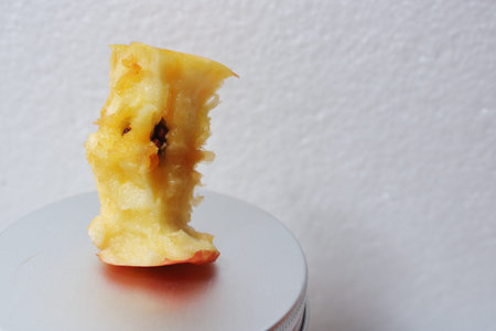 Minimalist close up of an eaten apple core against clean white background, showing texture, freshness, and simplicity. Perfect for health, diet, and nutrition themesの写真素材