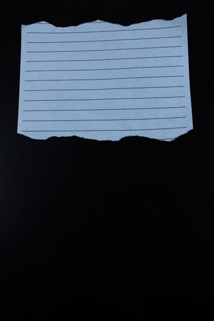 Torn Lined Paper on Black Background. Blank Note Sheet with Rough Edges for Message, Text Space, and...
