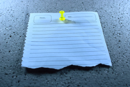 Torn Lined Note Paper Pinned with Yellow Thumbtack on Gray Textured Surface. Minimalist Memo Sheet...