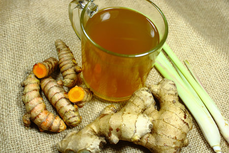 Herbal Turmeric and Ginger Tea with Lemongrass on Burlap, Healthy Traditional Antioxidant Drink and...