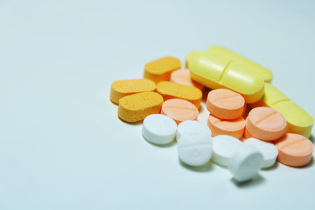 Close up of assorted colorful medicine tablets and pills on a white background. Pharmaceutical...