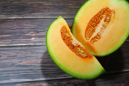 Fresh Cantaloupe Melon Slices on Rustic Wooden Background