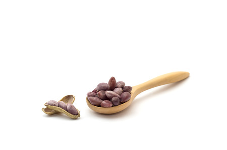 Peanut bean in wooden spoon with Peanut bean in wooden spoon on a white backgroundの写真素材