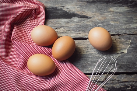 Chicken egg on old wooden backgroundの写真素材