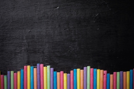 Multicolor chalk on desk for education backgroundの写真素材