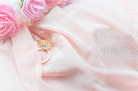 Diamond ring on pink fabric for valentine day or wedding backgroundの写真素材