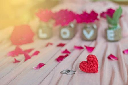 Close up of wedding rings andred heart handmade with love on the bottle for Valentine's day or wedding backgroundの写真素材