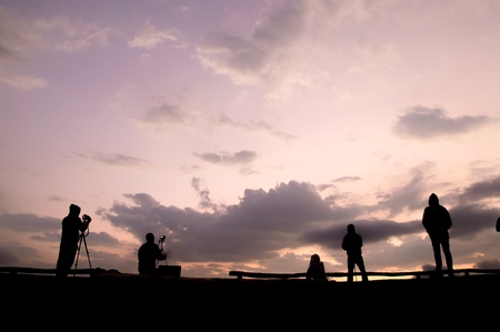 Silhouette of photographer waiting for the sunrise on the hillの写真素材
