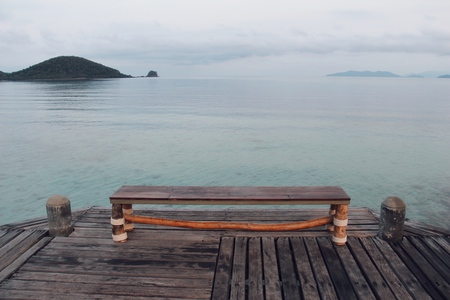 Wooden chair with blue sea backgroundの写真素材