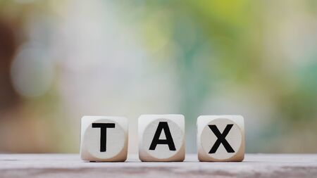Tax concept with tax wooden cubeの写真素材