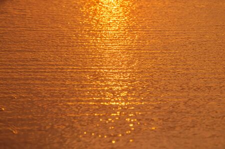 wet sand at the time of sunsetの写真素材