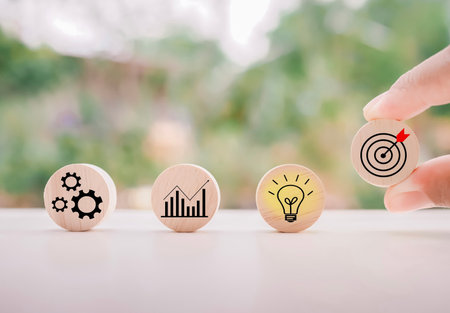 Close up hand arranging wooden block with  business strategy icons, Action plan and business process management concept.の写真素材