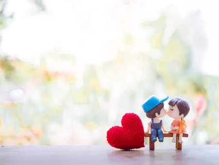 Close up of mini couple dolls in romantic kiss for Valentine's day conceptの写真素材