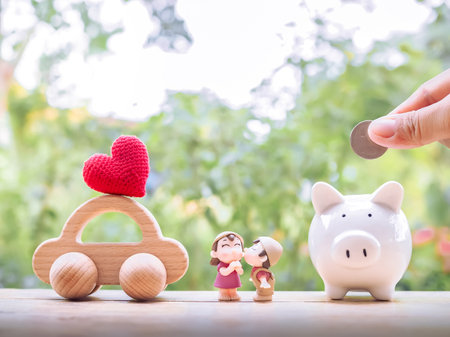 Piggy bank, wooden toy car and lovely couple. The concept of saving for car of family.の写真素材