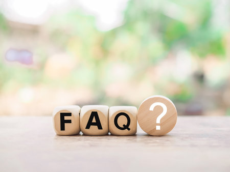 Wooden block with word the FAQ with question marks. The concept of question or answer time.の写真素材