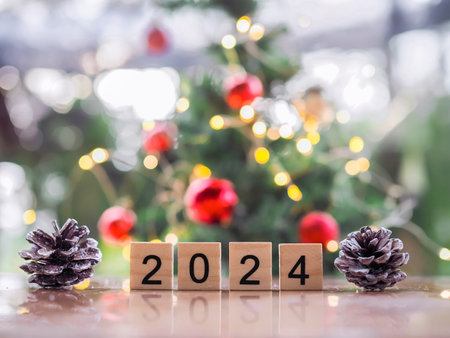 Close up of number 2024 and pinecones with Christmas light bokeh background. Merry Christmas and Happy New Year 2024の写真素材
