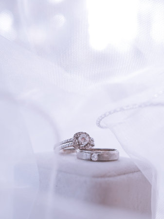 Wedding accessories. Diamond engagement wedding rings on white box. Valentine's day and Wedding day...