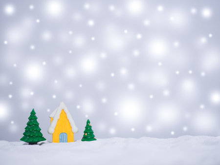 Christmas tree, Miniature house with shiny light for Christmas and New Year holidays background, Winter season, falling snow, Copy space for Christmas and New Year holidays greeting card.の写真素材