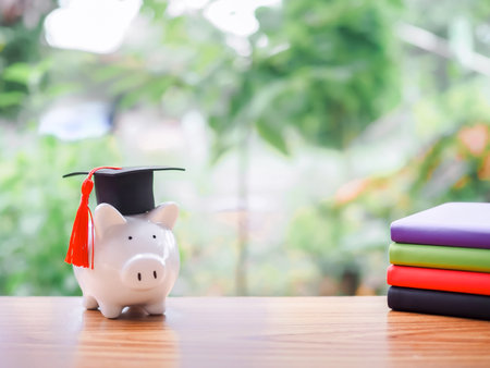 Piggy bank with graduation hat and hardcover book, Copy space for text, Back to school, Education conceptの写真素材