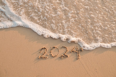 2024 year written on the beach in the sunset time. New Year 2024 concept