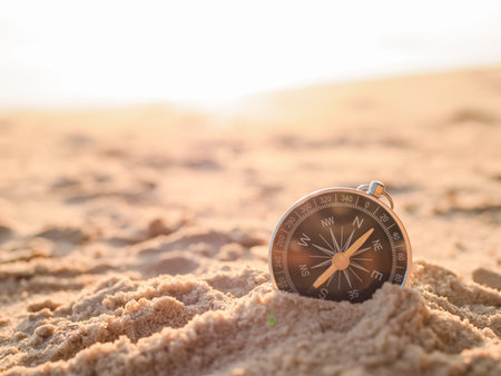 Close up hand holding compass with beach background. The concept of world tourism day, Searching the right directions and Travelの写真素材