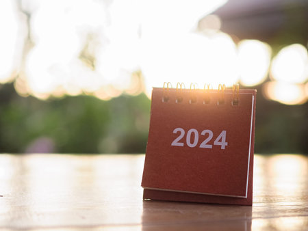 Close up 2024 desk calendar on the table with copy space. Resolution, Goal, Action, Planning, and...