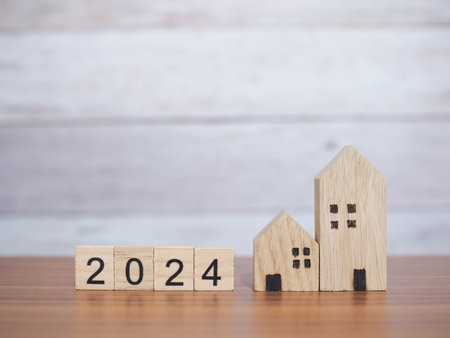 Wooden block with 2024 and miniature house. The concept of Property investment, House mortgage, Real...