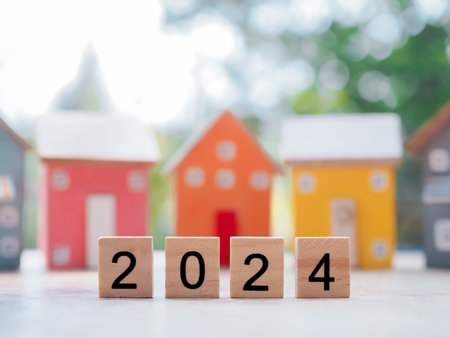 Wooden blocks with the number 2024 with Miniature house background. The concept of house, Property...