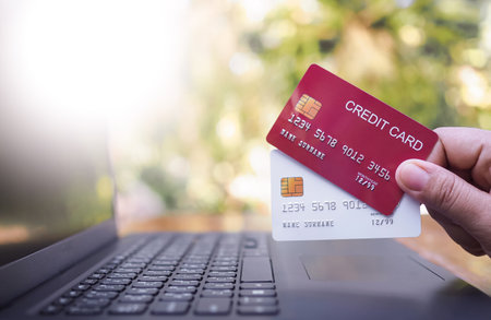 Woman hand holding several credit cards. The concept of Convenience in the world of technology and the internet, Online shopping, banking transaction, banking online and paymentの写真素材