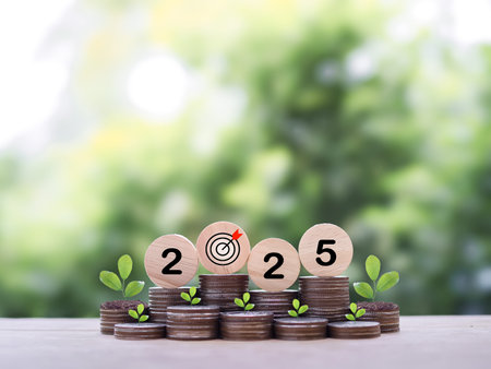 Wooden blocks with the number 2025 and plants growing up on stack of coins. The concept of saving...