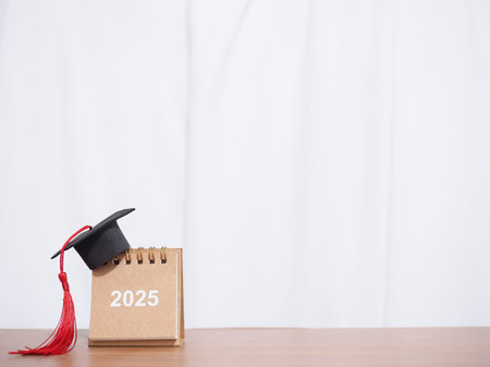 Study goals, 2025 Desk calendar with graduation hat. The concept for Resolution, Goal, Action,...
