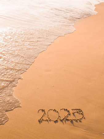 2025 year handwritten on the beach in the sunset time. New Year 2025 conceptの写真素材