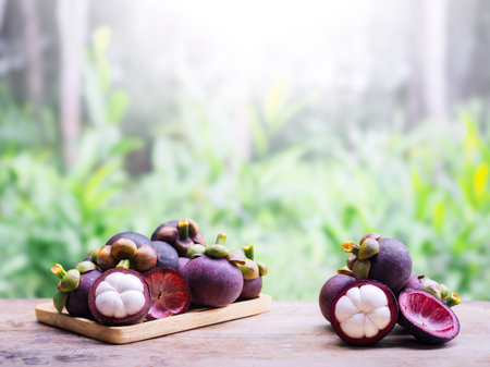 Ripe mangosteen on wooden table. Queen of fruits in Thailandの写真素材