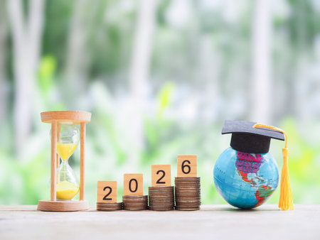 Study goals. Hourglass, Earth globe with graduation hat and stack of coins. The concept of saving...