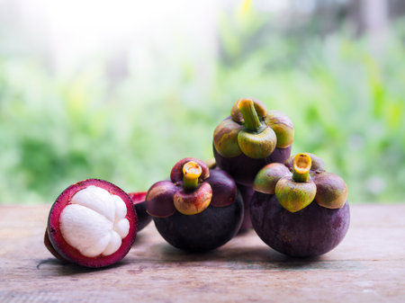 Ripe mangosteen on wooden table. Queen of fruits in Thailandの写真素材