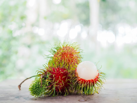 Close-up ripe rambutans on the wooden table.の写真素材