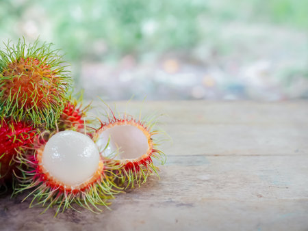 Close-up ripe rambutans on the wooden table.の写真素材