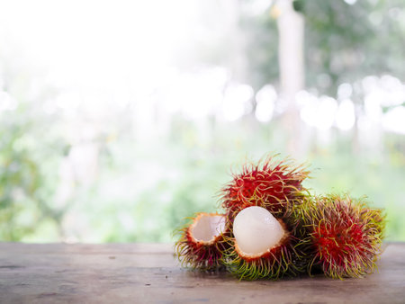 Close-up ripe rambutans on the wooden table.の写真素材