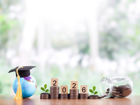 Earth globe with graduation hat, Wooden block with number 2026 and plant growing on stack of coins....