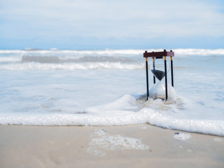 Hourglass on the beach. The concept about countdown to Summer, Travel, Vacation and Relaxation.