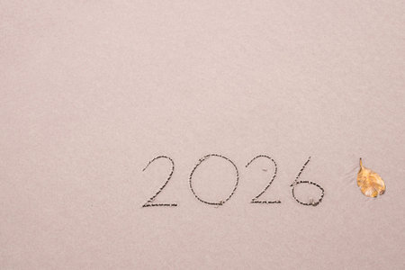 2026 year handwritten on the beach in the sunset time. New Year 2026 concept