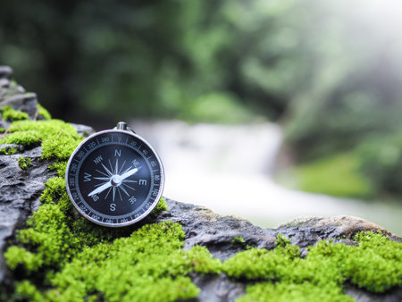 Compass on the rock with waterfall as background. The concept of world tourism day, Searching the right directions and Travelの写真素材