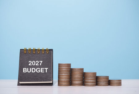 2027 desk calendar and stack of coins. The concept about budget planning and allocation in year 2027の写真素材