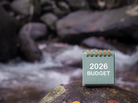 2026 desk calendar on the rock with waterfall as background. The concept about budget planning and...