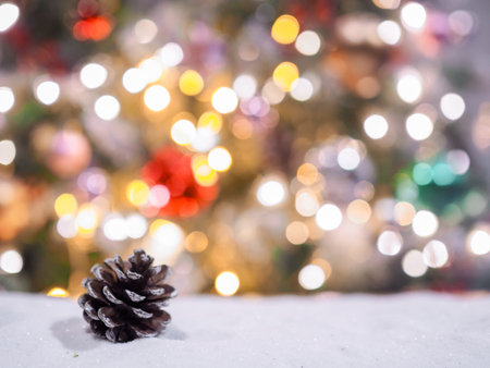 Close-up of pine cones with christmas light backgroundの写真素材